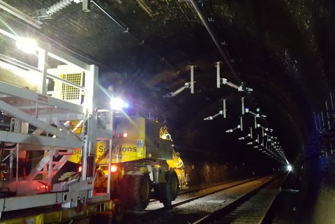Engineers at work in the nighttime on the installation of electrification equipment