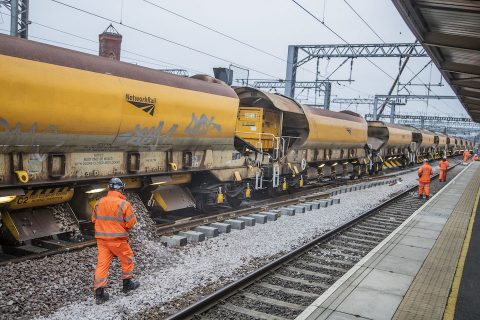 Network Rail engineering train and workers in orange suits