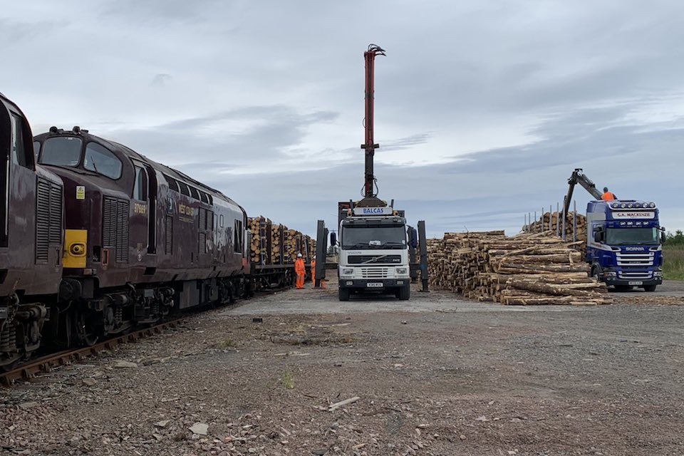 Loading raw timber onto rail wagons at Scottish terminal in the far north