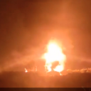 Night fire with flames rising into the sky at Llangennech in Wales after crash