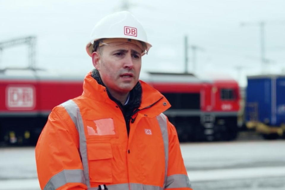 Andrea Rossi the chief executive of DB Cargo UK out in the field, wearing orange jacket and hard hat