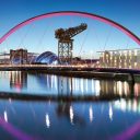 View through the arch of the Clyde Bridge showing Glasgow's riverfront, featuring the Scottish-Exhibition and Conference Centre
