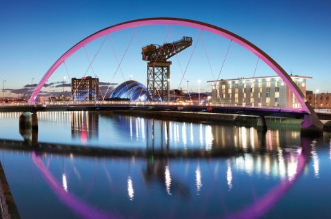 View through the arch of the Clyde Bridge showing Glasgow's riverfront, featuring the Scottish-Exhibition and Conference Centre