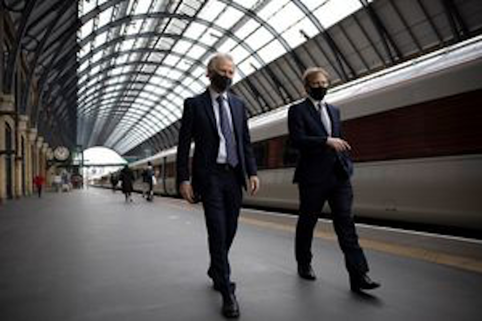 Network Rail chair Peter Hendy and former transport secretary Grant Shapps leave the platform at London King's Cross 