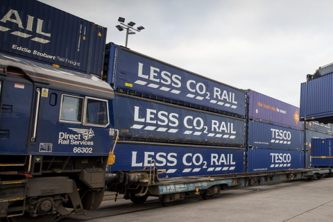 Tesco DRS containers stacked three high next to a DRS locomotive