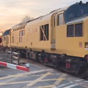 Three quarter shot of two class 37 diesels at level crossing in Aberystwyth