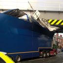 articulated lorry damaged and stuck under railway bridge