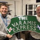 Varamis Express nameplate held up by Phil Read the company owner and staff member