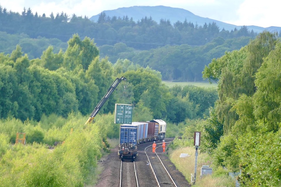 Container being unloaded by crane from army train in the Scottish Highlands