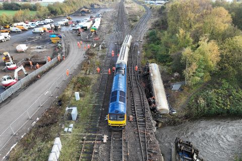 Locomotive towing away cement trucks from Carlisle derailment