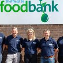Volunteers from VolkerRail pose outside Sheffield Food Banks warehouse with logo