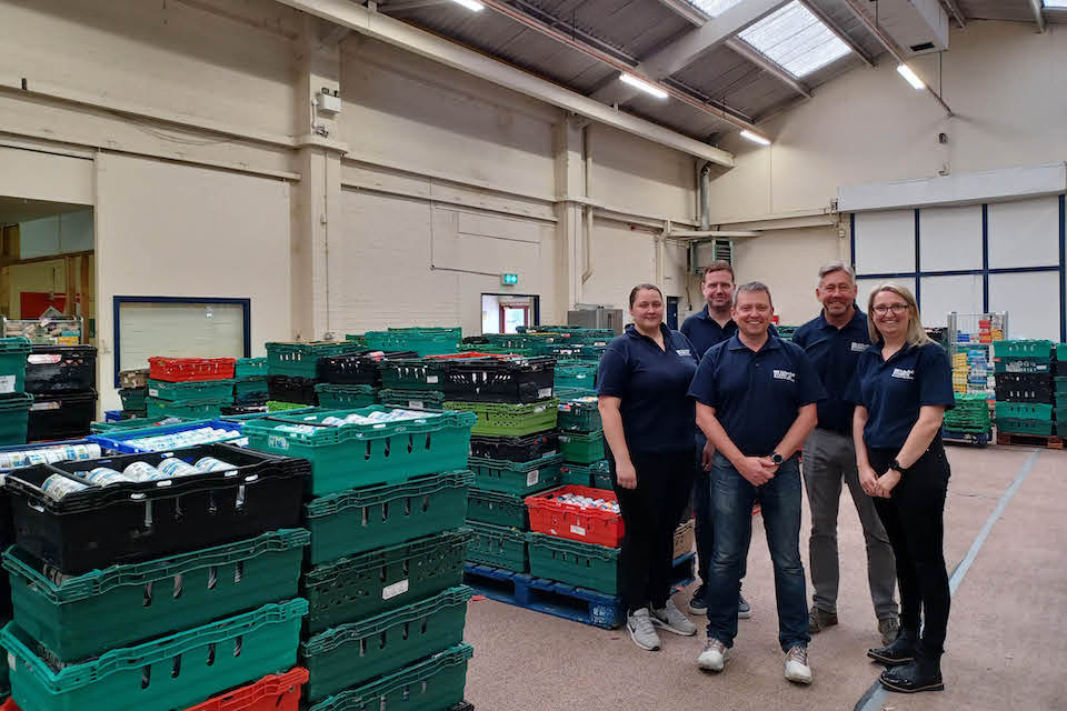 VolkerRail volunteers inside Sheffield Food Banks warehouse with green crates