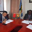 Jingjun Li, CEO of CHEC, and Waiswa Bageya, Permanent Secretary of the ministry of Works and Transport, signing the deal in 2019