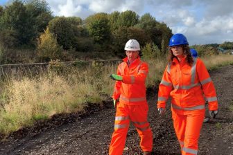 Network Rail project manager Martin McKinlay and local member of Parliament Wendy Chamberlain in orange safety suits walking the line of the Levenmouth Rail Link project
