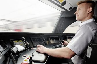 Train driver in cab at the controls