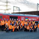 DB Cargo staff pose in front of special "Rail aid for Ukraine" locomotive