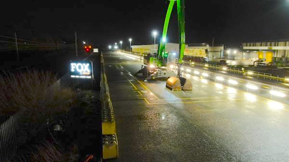 Night time image of mechanical shovel at Leyland Enterprise Sidings with Fox Group sign illuminated