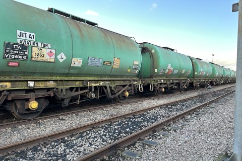 Long shot of line of tank wagons painted green and standing in a siding at Gascoigne Wood