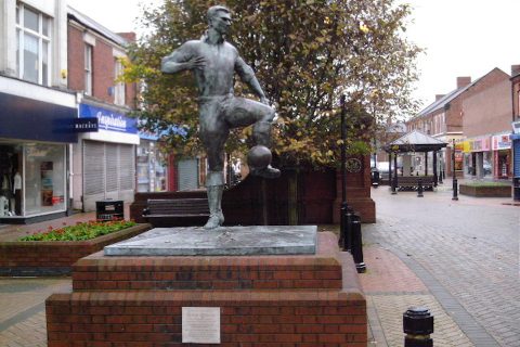 The statue of the Newcastle United and England footballer Jackie Milburn in Station Road, Ashington, Northumberland.