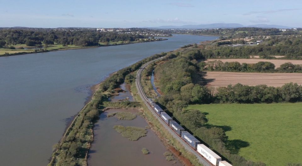 Aerial shot of intermodal train by the banks of the River Suir in Waterford, Ireland