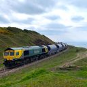 Freight train on the Boulby Mine branch at cliffs near Saltburn with the sea in background