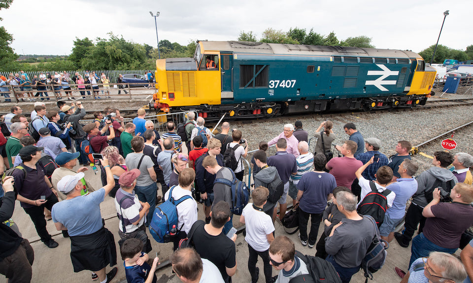 Appreciative crowd look on as a freshly outshopped class 37 diesel passes by at DRS Open Day at Crewe