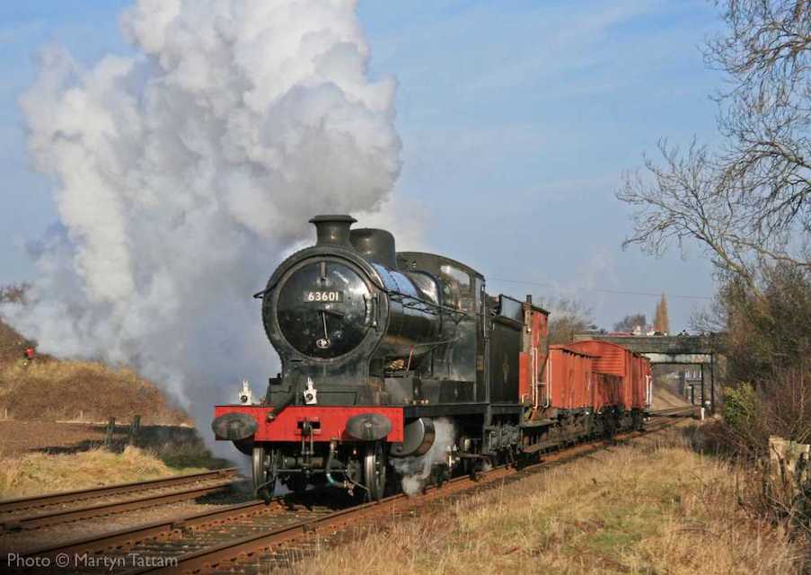 Small steam locomotive approaching with a short goods train on the Great Central Railway