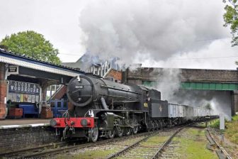 Steam locomotive approaching with a goods train on the Great Central Railway