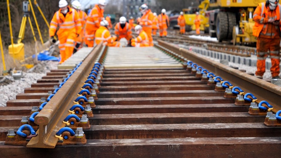 Track level view of engineers at work replacing a track panel
