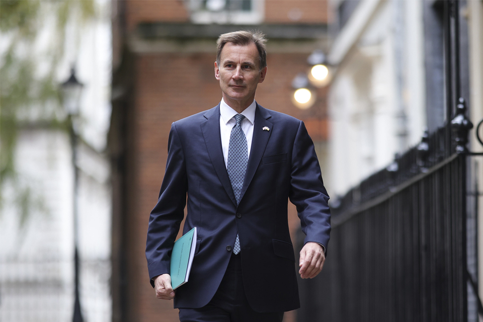 British politician Jeremy Hunt striding down a Whitehall street in London.