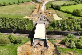 Overhead view of the new raod bridge at Roade, spanning a deep cutting of the West Coast Main Line Northampton Loop, in lush green countryside