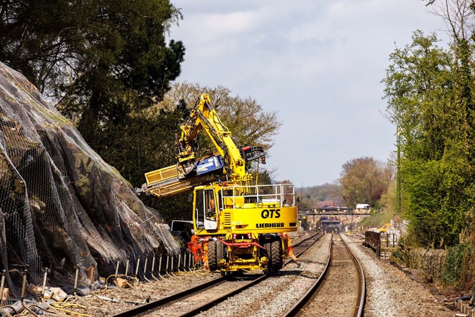 QTS Mega Reach road rail vehicle - a rail mounted drilling machine, at work on the Severn Estuary Line, seen from the trackside