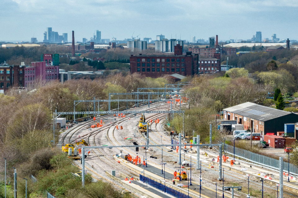 With Leeds city centre on the horizon, engineers work on tracks in the foreground