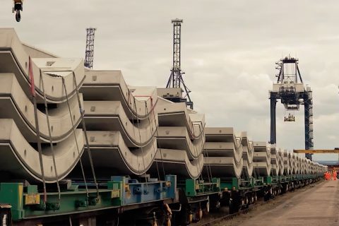 A train loaded with semi-circular concrete tunnel lining segments ready to depart for the HS2 site in London