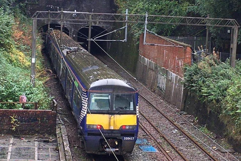 On a wet day a train enters the tunnel at Dalmuir, which has just recovered from flooding