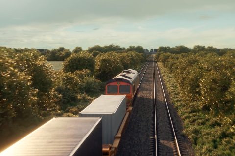 Video still of an intermodal train viewed from an over bridge as the locomotive and leading wagons travel away into the distance in a rural setting