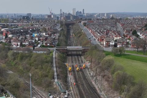 Aerial view of track work in the Neville Hill area of Leeds with the city skyline in the background