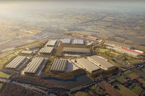 CGI of aerial view of West Midlands Interchange showing warehouses in foreground and countryside behind