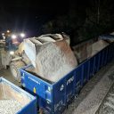 At night a huge mechanical shovel discharges a load into an open wagon