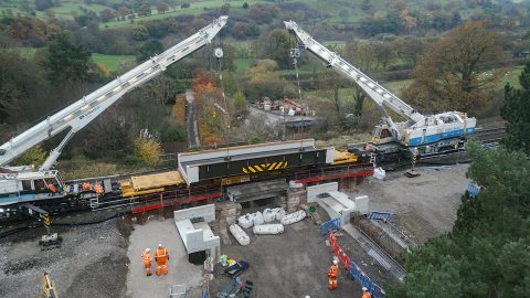 Sky shot of cranes lifting bridge into place at Bamford in the Hope Valley